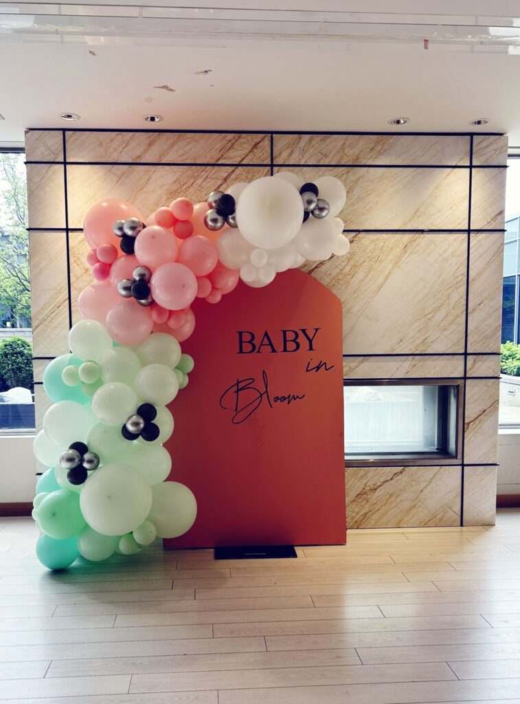 balloon garland, backdrop and sign for a baby shower