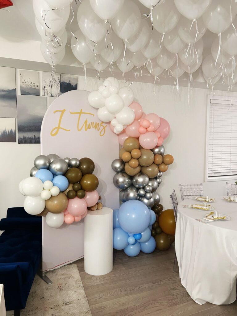 balloon decor and a backdrop with event furniture